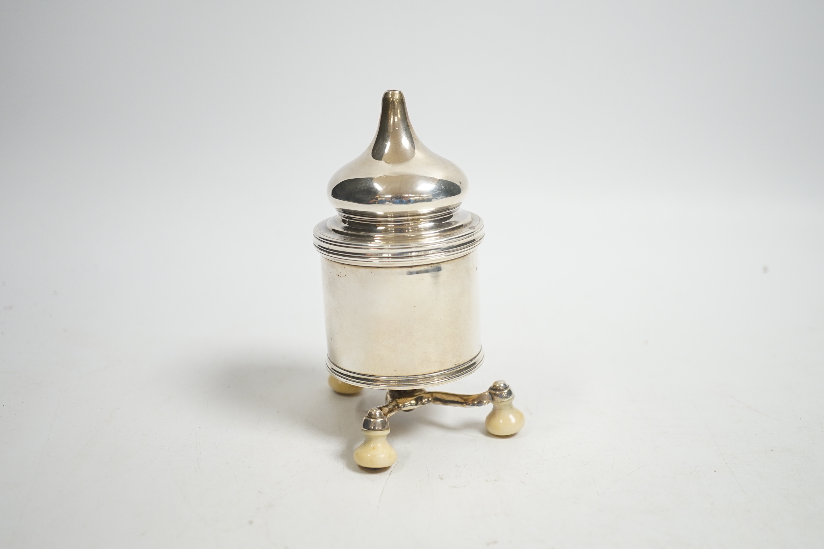 A French white metal pepper grinder on three ivory feet, height 11.5cm CITES Submission reference: JWYF7WUN